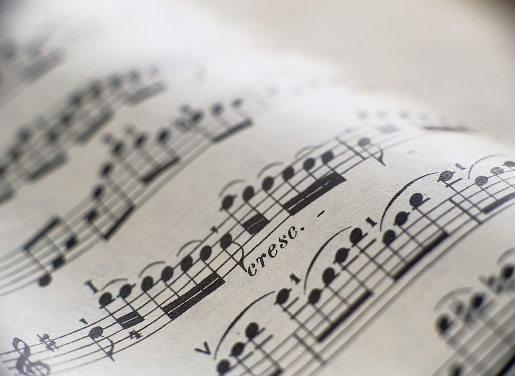 Sheet music with a cello part, crescendo marking in focus